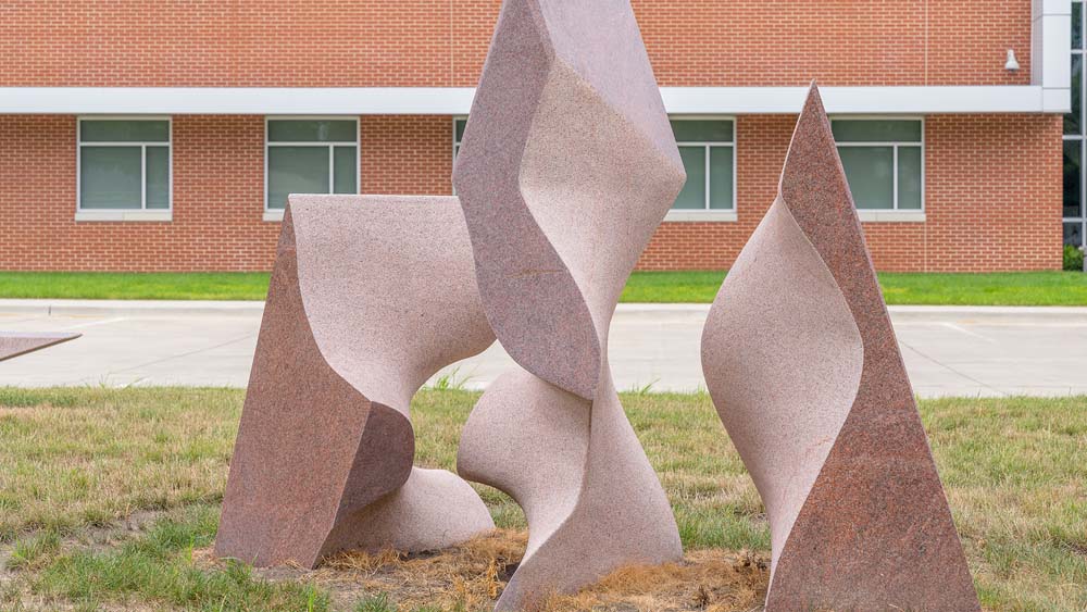 Symbiosis sculpture with triangular shapes of stone