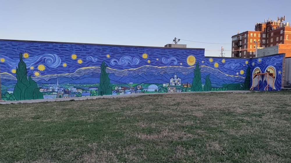 The Starry Night of Marshalltown mural inspired by Van Gogh with a night view of Marshalltown