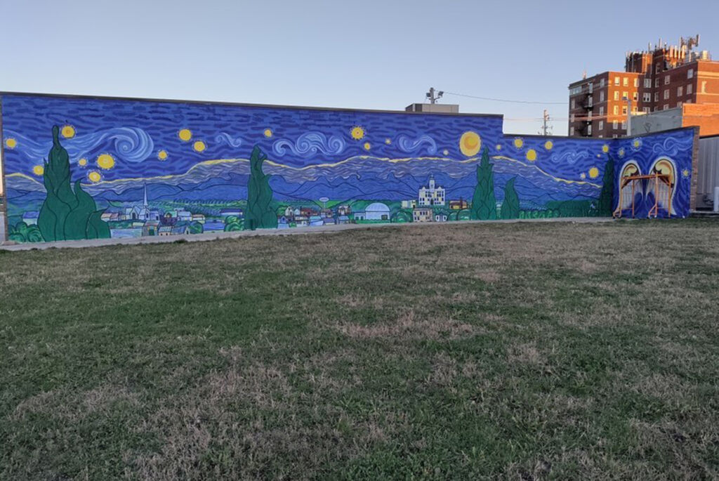 A mural that depicts Marshalltown in the style of Van Gogh's Starry Starry Night