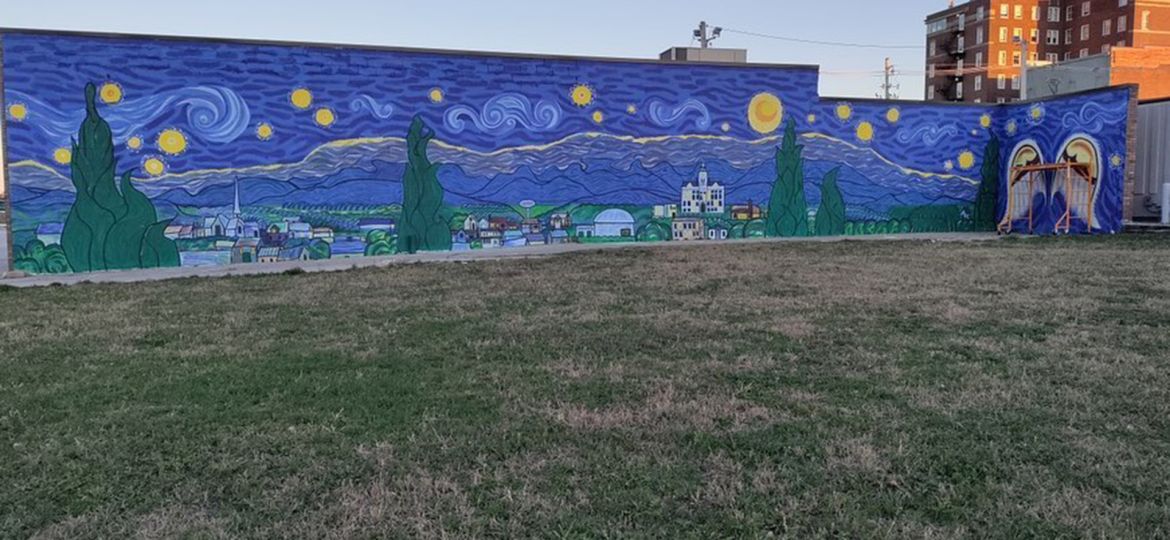 A mural that depicts Marshalltown in the style of Van Gogh's Starry Starry Night