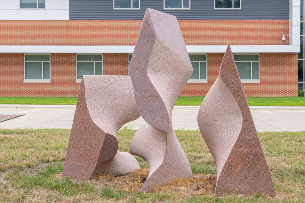 Symbiosis installed - three stone triangular-like shapes in various heights with curves