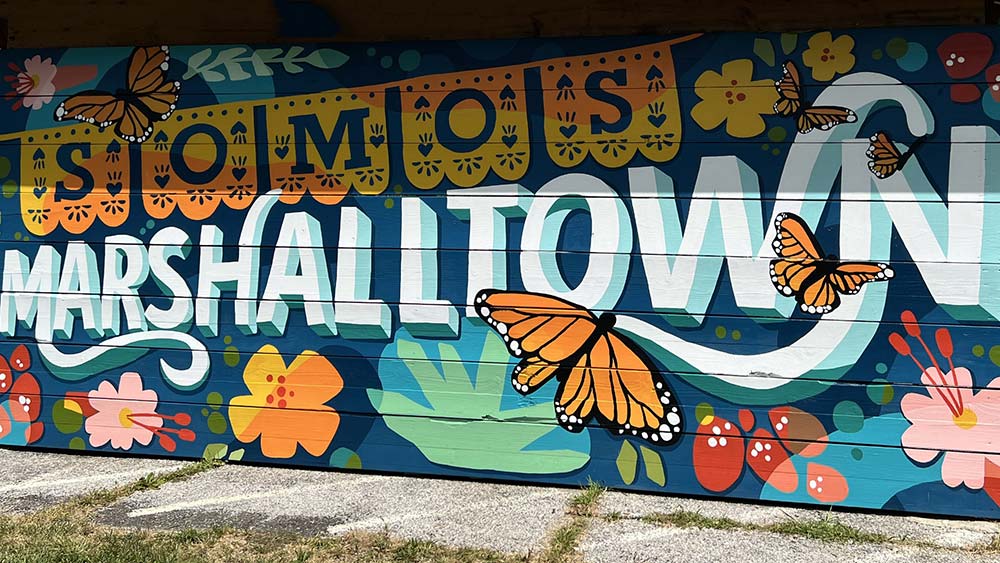 Somos Marshalltown mural with butterflies and flowers